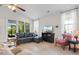 Bright living room with vaulted ceilings, a large window, and comfortable seating at 637 Grand Cypress Way, Murrells Inlet, SC 29576