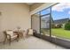 Cozy screened porch featuring wicker furniture and views of the green backyard at 637 Grand Cypress Way, Murrells Inlet, SC 29576