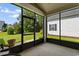Relaxing screened porch overlooking a well-maintained lawn with mature trees at 637 Grand Cypress Way, Murrells Inlet, SC 29576