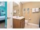 Bright bathroom with a wooden vanity, mirror, and coordinated decor at 704 S Ocean Blvd. # 304A, Myrtle Beach, SC 29577