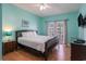 Charming bedroom features a queen-size bed, an adjacent balcony, and neutral laminate flooring at 704 S Ocean Blvd. # 304A, Myrtle Beach, SC 29577