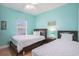 Comfortable bedroom featuring two twin beds, soft natural lighting, and attractive laminate flooring at 704 S Ocean Blvd. # 304A, Myrtle Beach, SC 29577