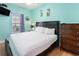 Relaxing bedroom featuring a large bed, light blue walls, and hardwood floors at 704 S Ocean Blvd. # 304A, Myrtle Beach, SC 29577