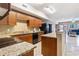 Efficient kitchen featuring wooden cabinets, granite countertops, and modern black appliances at 704 S Ocean Blvd. # 304A, Myrtle Beach, SC 29577