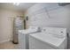 Functional laundry room featuring a washer, dryer and hot water heater at 704 S Ocean Blvd. # 304A, Myrtle Beach, SC 29577