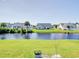 Beautiful backyard overlooking a tranquil pond, surrounded by well-maintained lawns and other homes at 708 Shenanigan Loop, Murrells Inlet, SC 29576