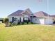 Attractive home featuring a well-kept lawn and an attached garage in a Gathering-friendly community at 708 Shenanigan Loop, Murrells Inlet, SC 29576
