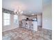 Well-appointed kitchen with a breakfast bar, white cabinetry, and modern chandelier at 708 Shenanigan Loop, Murrells Inlet, SC 29576
