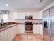 Updated kitchen boasts stainless steel appliances and white cabinets at 708 Shenanigan Loop, Murrells Inlet, SC 29576