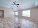 Spacious living room with ceiling fans, neutral walls, and large windows for plenty of natural light at 708 Shenanigan Loop, Murrells Inlet, SC 29576