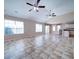 Open living area featuring tile flooring, multiple ceiling fans, and lots of natural light from large windows at 708 Shenanigan Loop, Murrells Inlet, SC 29576