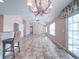 Large living room with tile flooring, a decorative chandelier, and sliding glass doors to an outdoor space at 708 Shenanigan Loop, Murrells Inlet, SC 29576