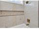 Modern bathroom featuring a tiled shower with gold fixtures and a built-in niche with decorative stone accents at 729 Jade Dr., Myrtle Beach, SC 29579
