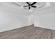 Spacious bedroom with grey flooring, white walls, and ceiling fan at 729 Jade Dr., Myrtle Beach, SC 29579