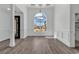 Spacious dining room with large window, chandelier, grey flooring and classic white wall trim at 729 Jade Dr., Myrtle Beach, SC 29579