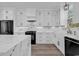 Bright kitchen featuring white cabinetry, modern appliances, marble countertops and backsplash, and stainless steel fixtures at 729 Jade Dr., Myrtle Beach, SC 29579