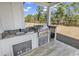 Outdoor kitchen featuring a grill, counter space, and stainless steel appliances overlooking the yard at 729 Jade Dr., Myrtle Beach, SC 29579