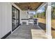 Covered patio featuring outdoor kitchen with grill, mini-fridge, and granite countertops at 729 Jade Dr., Myrtle Beach, SC 29579