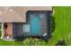 Aerial view of a screened-in pool and jacuzzi framed by lush landscaping at 7961 San Marcello Dr., Myrtle Beach, SC 29579