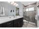 Bathroom featuring a shower with glass door, ceramic tile walls, and a dark vanity with a white countertop at 7961 San Marcello Dr., Myrtle Beach, SC 29579