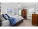 The bedroom features carpet, a bed with blue bedding, and plenty of natural light at 7961 San Marcello Dr., Myrtle Beach, SC 29579