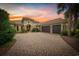 Stunning home featuring a brick driveway, a tile roof, and an attached three-car garage at 7961 San Marcello Dr., Myrtle Beach, SC 29579