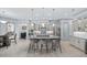 Bright kitchen features a large island with bar seating, stainless steel appliances, and pendant lighting at 7961 San Marcello Dr., Myrtle Beach, SC 29579