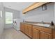 Laundry room with front load washer and dryer, storage, and large countertop at 7961 San Marcello Dr., Myrtle Beach, SC 29579