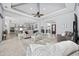Open-concept living room features a tray ceiling, a ceiling fan, and gray walls at 7961 San Marcello Dr., Myrtle Beach, SC 29579