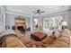 Living room with brown sectional, leather ottoman, and view of backyard patio with pool at 7961 San Marcello Dr., Myrtle Beach, SC 29579