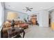 Cozy living room featuring a brown sectional, leather ottoman, and vintage hutch with desk at 7961 San Marcello Dr., Myrtle Beach, SC 29579