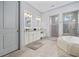 A full view of the primary bathroom featuring tub, walk-in shower, and double vanity with granite countertop at 7961 San Marcello Dr., Myrtle Beach, SC 29579