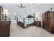 An angled view shows the spacious main bedroom featuring dark wood furniture and a trey ceiling at 7961 San Marcello Dr., Myrtle Beach, SC 29579