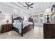 Spacious main bedroom boasts a trey ceiling, dark wood furniture, and an abundance of natural light at 7961 San Marcello Dr., Myrtle Beach, SC 29579