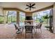 Outdoor dining on the patio with fireplace, screened-in pool, and view of landscaped backyard at 7961 San Marcello Dr., Myrtle Beach, SC 29579