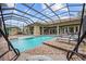 Backyard enclosed pool with water features, lounging chairs, and view of landscaped yard at 7961 San Marcello Dr., Myrtle Beach, SC 29579