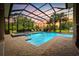 Enclosed pool with fountains, pavers, outdoor lounge chairs, and lush landscaping at sunset at 7961 San Marcello Dr., Myrtle Beach, SC 29579