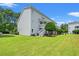 This exterior shot shows a spacious backyard with lush green grass and a staircase to the second floor at 801 Burcale Rd. # K7, Myrtle Beach, SC 29579