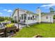 Charming backyard featuring a patio, lush green grass, and the home's exterior at 809 Berrywood Ct., Myrtle Beach, SC 29588