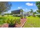 Exterior view of a home featuring an RV carport, lush greenery, and a well-maintained lawn at 809 Berrywood Ct., Myrtle Beach, SC 29588