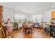 Charming dining area featuring natural light, wood floors, and classic table setting at 809 Berrywood Ct., Myrtle Beach, SC 29588