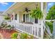 Inviting front porch with white railing, ceiling fan, hanging plants, and decorative accents at 809 Berrywood Ct., Myrtle Beach, SC 29588