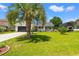 Attractive home featuring a large palm tree in the front yard and a covered trailer parking area at 809 Berrywood Ct., Myrtle Beach, SC 29588