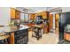 Functional kitchen with wood cabinets, black countertop island, and farmhouse décor accents at 809 Berrywood Ct., Myrtle Beach, SC 29588