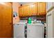 Well-organized laundry area with wooden cabinets, modern washer and dryer, and functional storage at 809 Berrywood Ct., Myrtle Beach, SC 29588