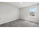 A sun-lit bedroom with soft carpet and a view from the large window at 8249 Vibrant Loop, Longs, SC 29568