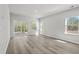 Open-concept living room with sliding glass doors, hardwood floors, and neutral color palette at 8249 Vibrant Loop, Longs, SC 29568