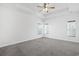 Spacious carpeted bedroom with three windows and a ceiling fan providing ample lighting at 865 Summer Starling Pl., Myrtle Beach, SC 29577