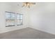 Bright bedroom with neutral carpet, ceiling fan, and two windows with a view at 865 Summer Starling Pl., Myrtle Beach, SC 29577