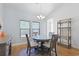 Bright dining area with wood floors, a glass-top table, and natural light from the window at 865 Summer Starling Pl., Myrtle Beach, SC 29577